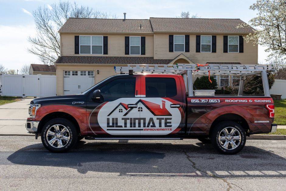 Ultimate Improvements branded roofing and siding service truck